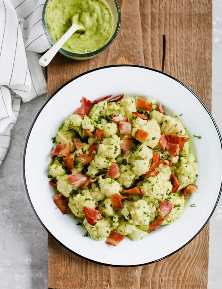 Overhead photo of a white plate of creamy avocado cauliflower salad.