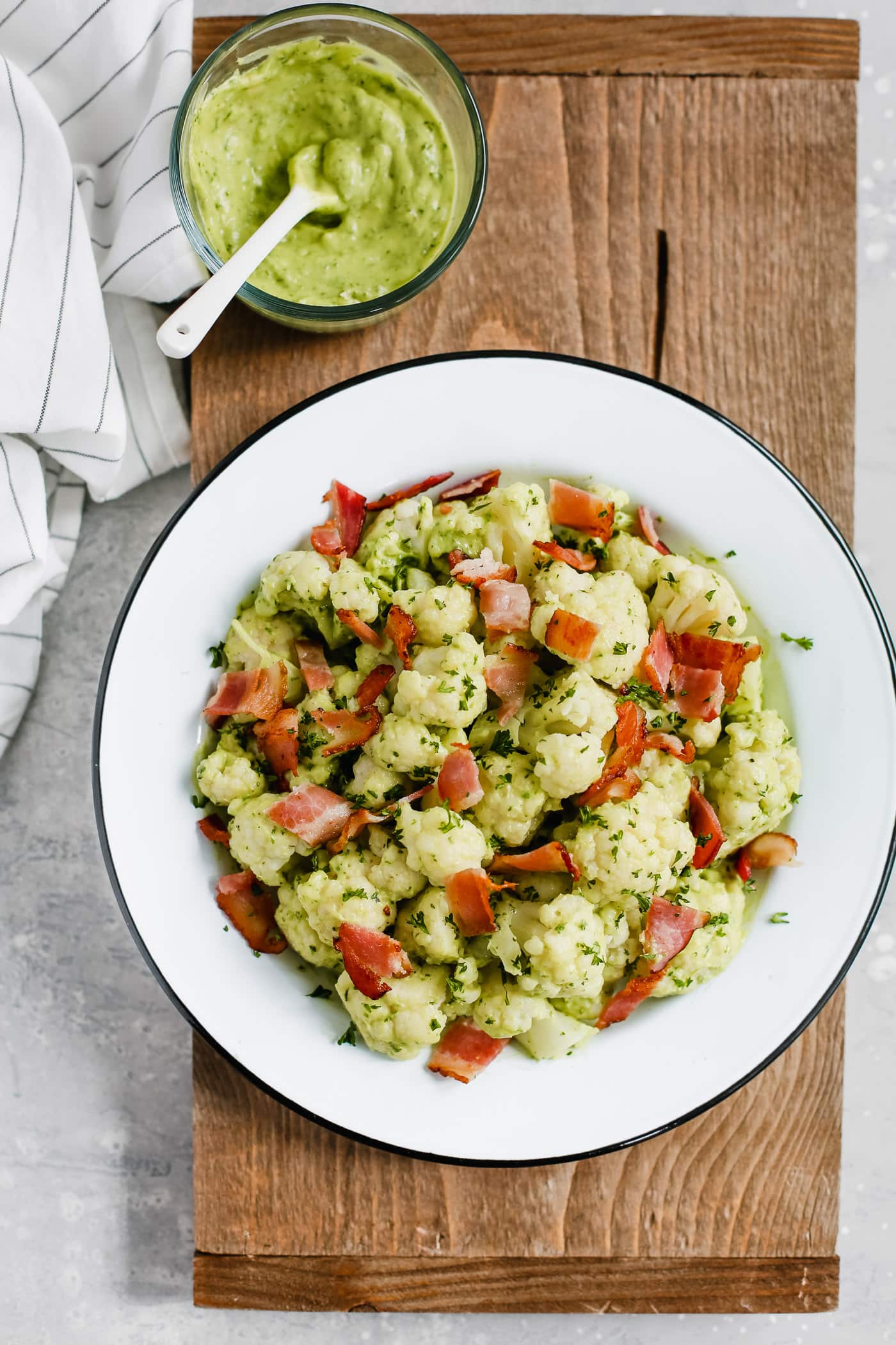 Overhead photo of a white plate of creamy avocado cauliflower salad.