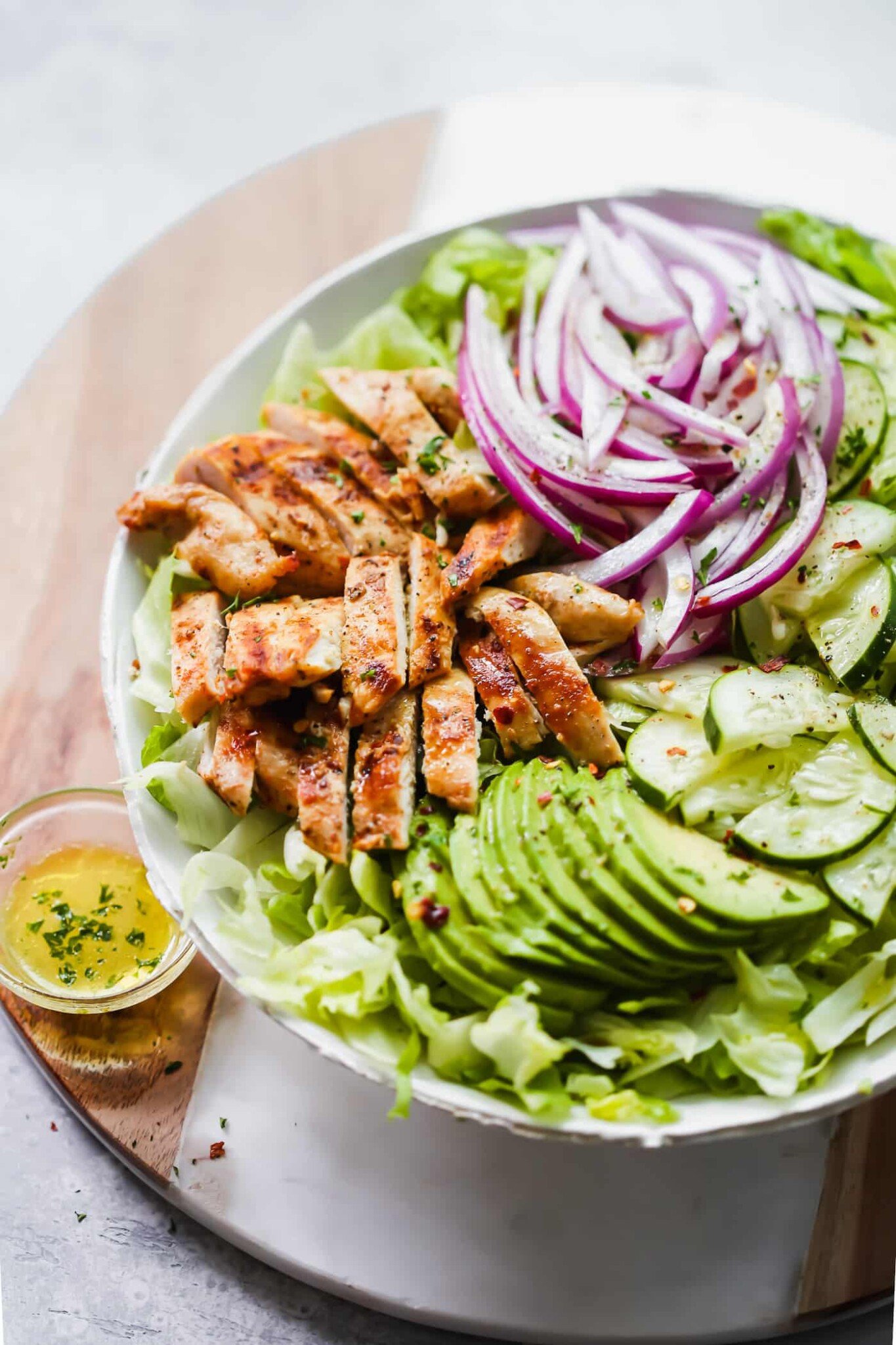 Grilled avocado chicken salad in a white bowl. 