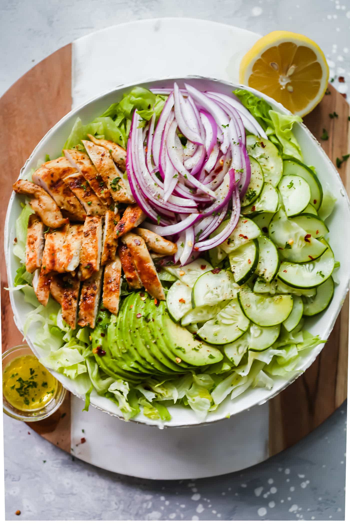 A large bowl of grilled chicken avocado salad for a gluten free dinner.