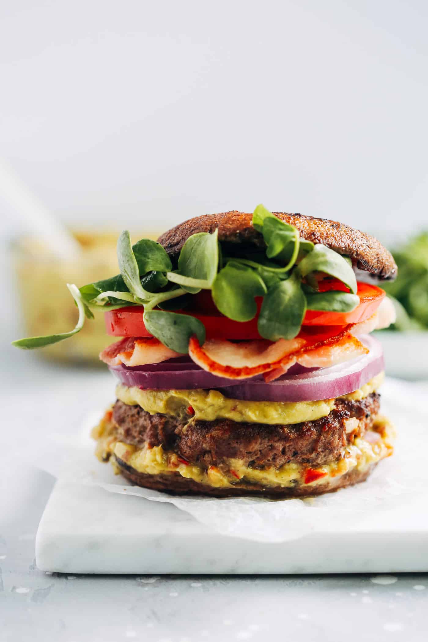 Close-up of a low-carb burger on a marble board.