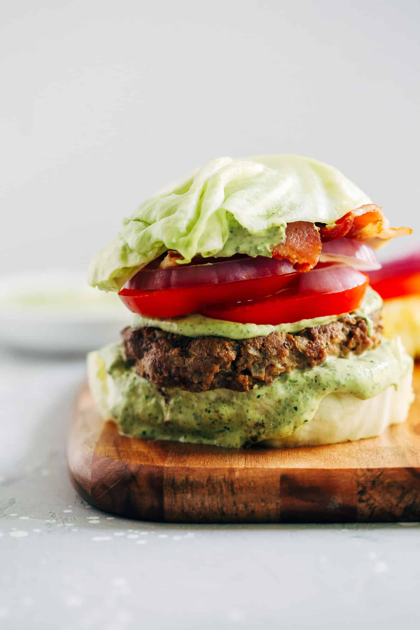 Close-up of a low-carb burger on a wooden board.