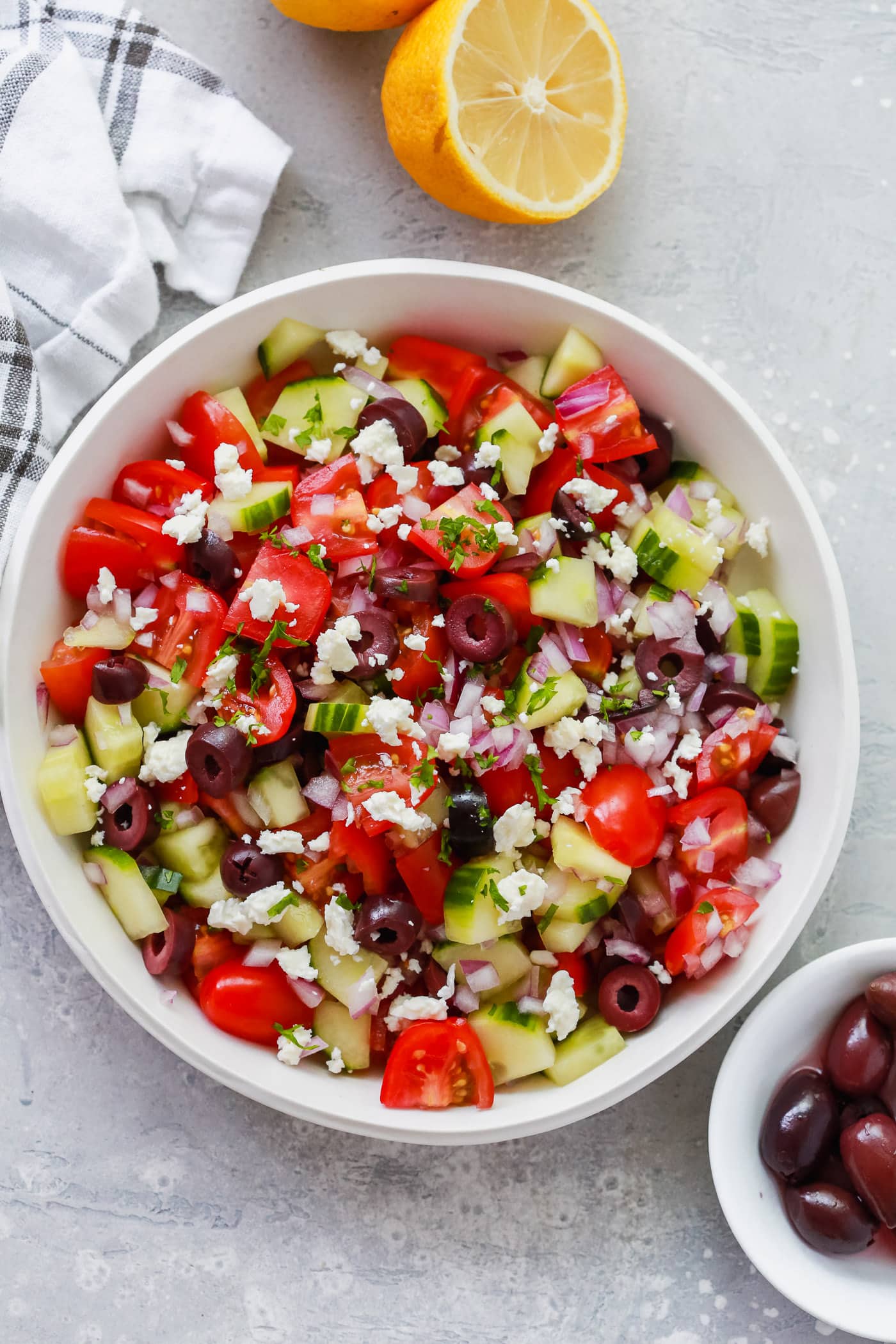 Overhead photo of a white bowl of mediterranean salad - Healthy Salad Recipes.