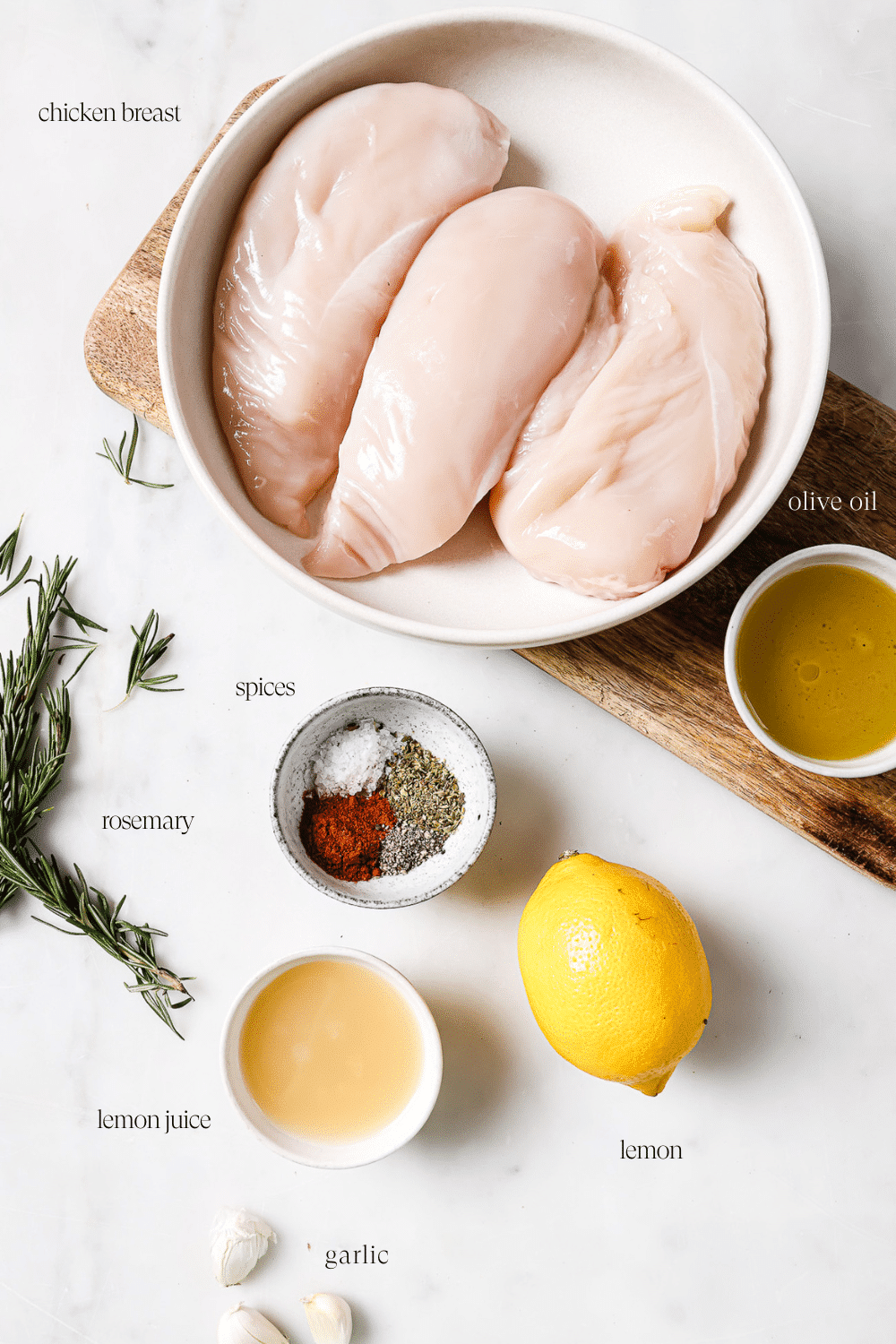 Prepped ingredients on a cutting board and white countertop.