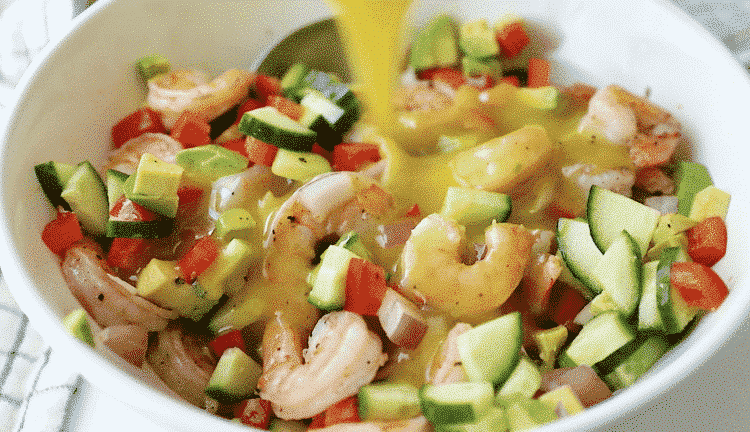 close up of shrimp avocado cucumber salad bowl