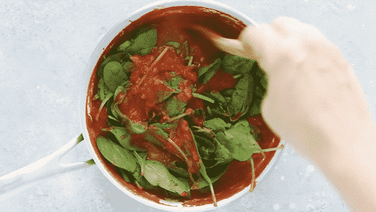 overhead view of tomato sauce with spinach