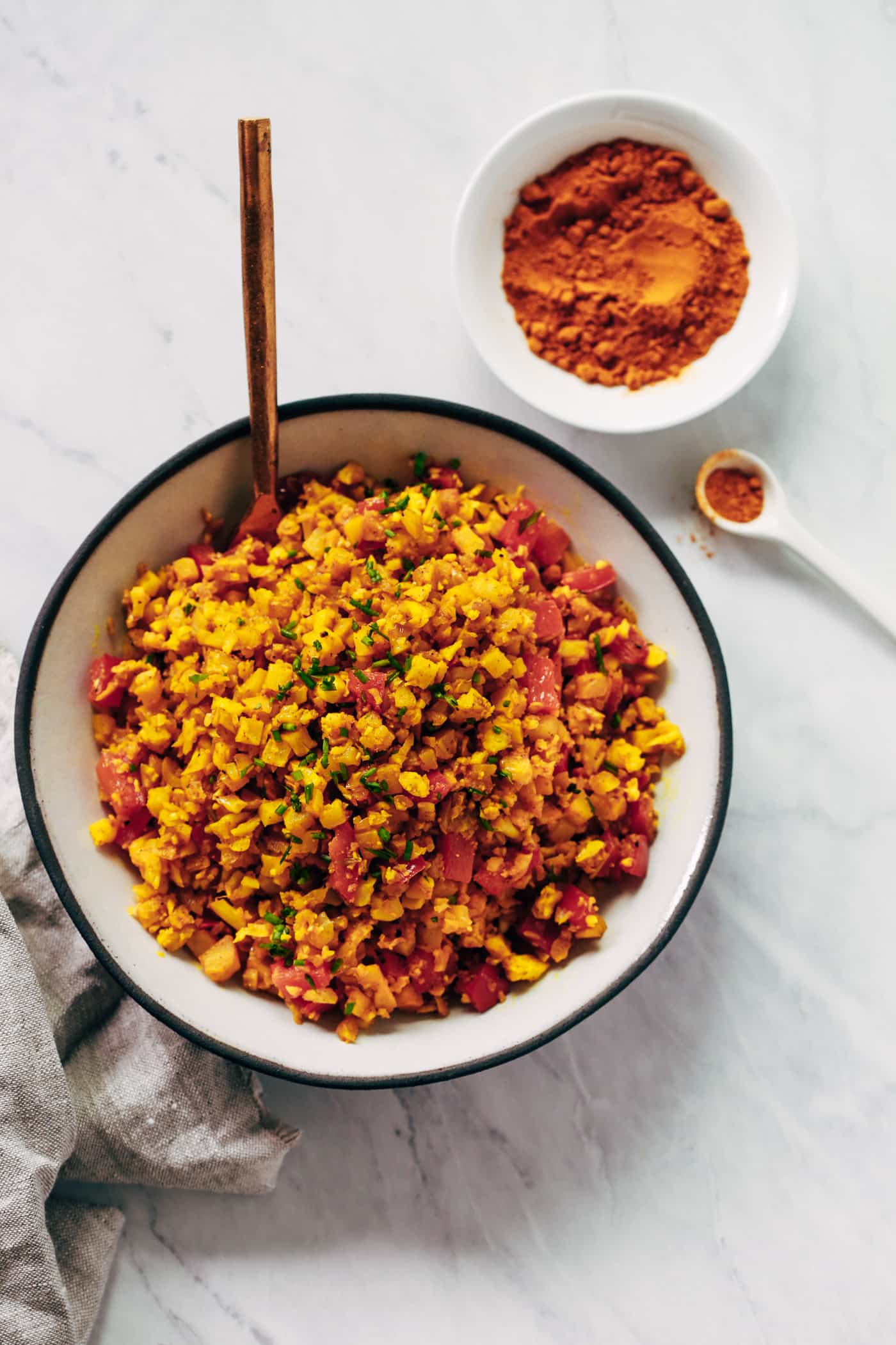 Overhead photo of a bowl of golden cauliflower rice.