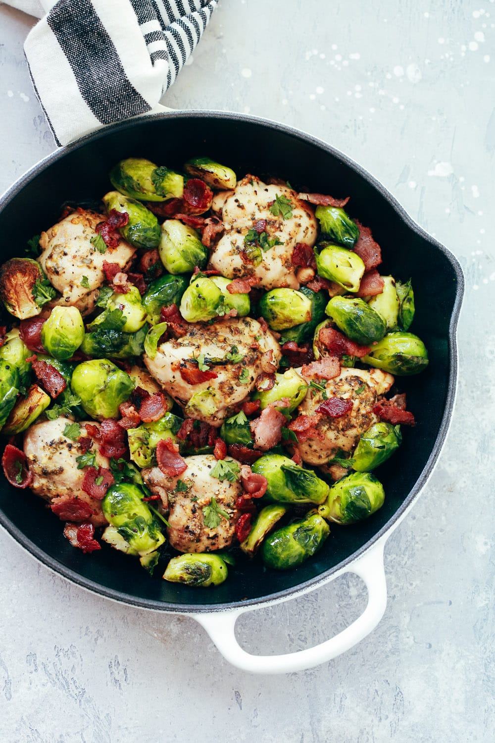 close up of a cast iron skillet containing Chicken and Brussels sprout