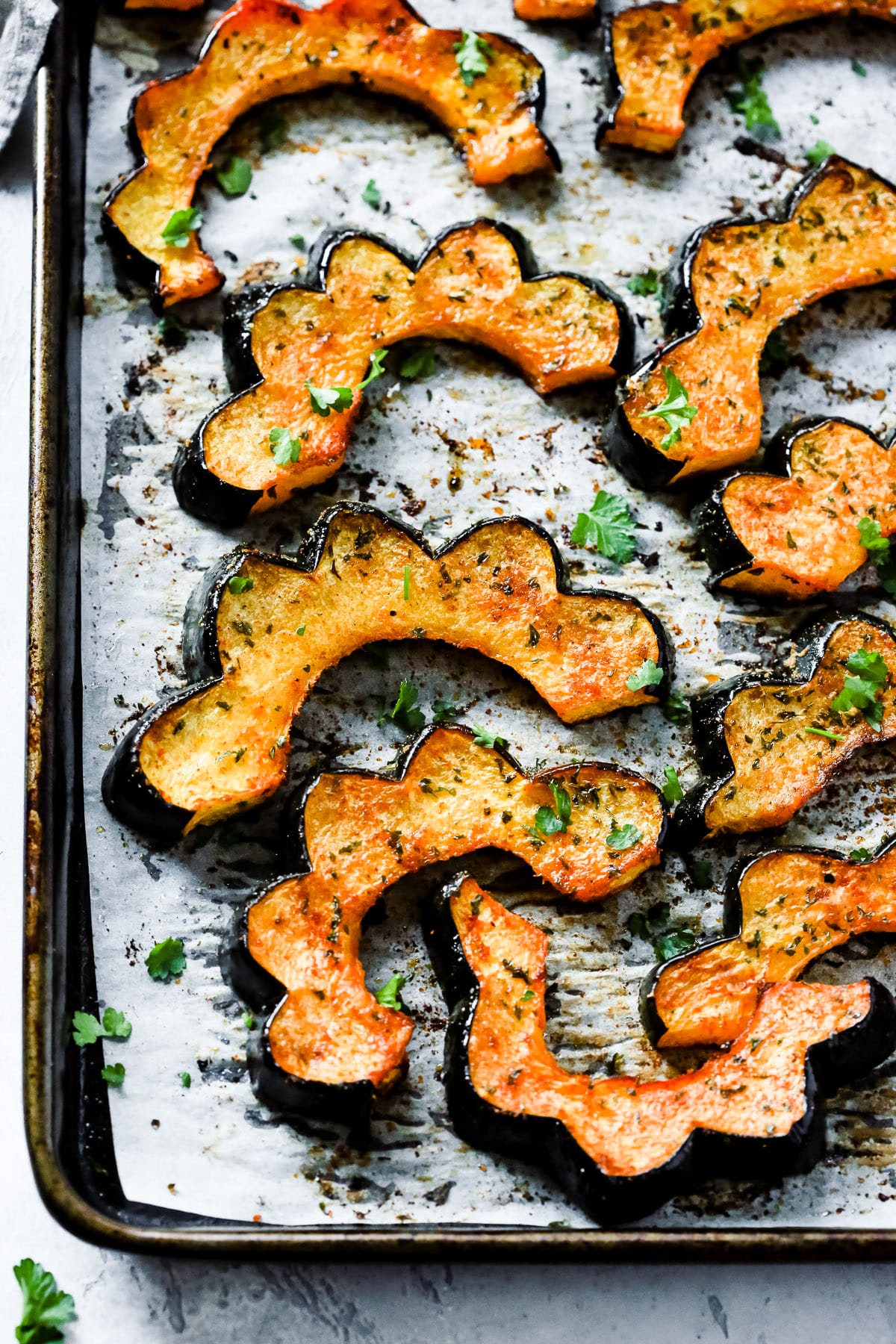 Overhead photo of roasted acorn squash on a sheet pan.