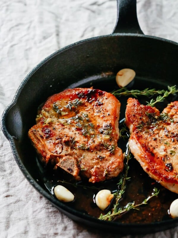 overhead view of Garlic Butter Baked Pork Chops in a cast iron skillet