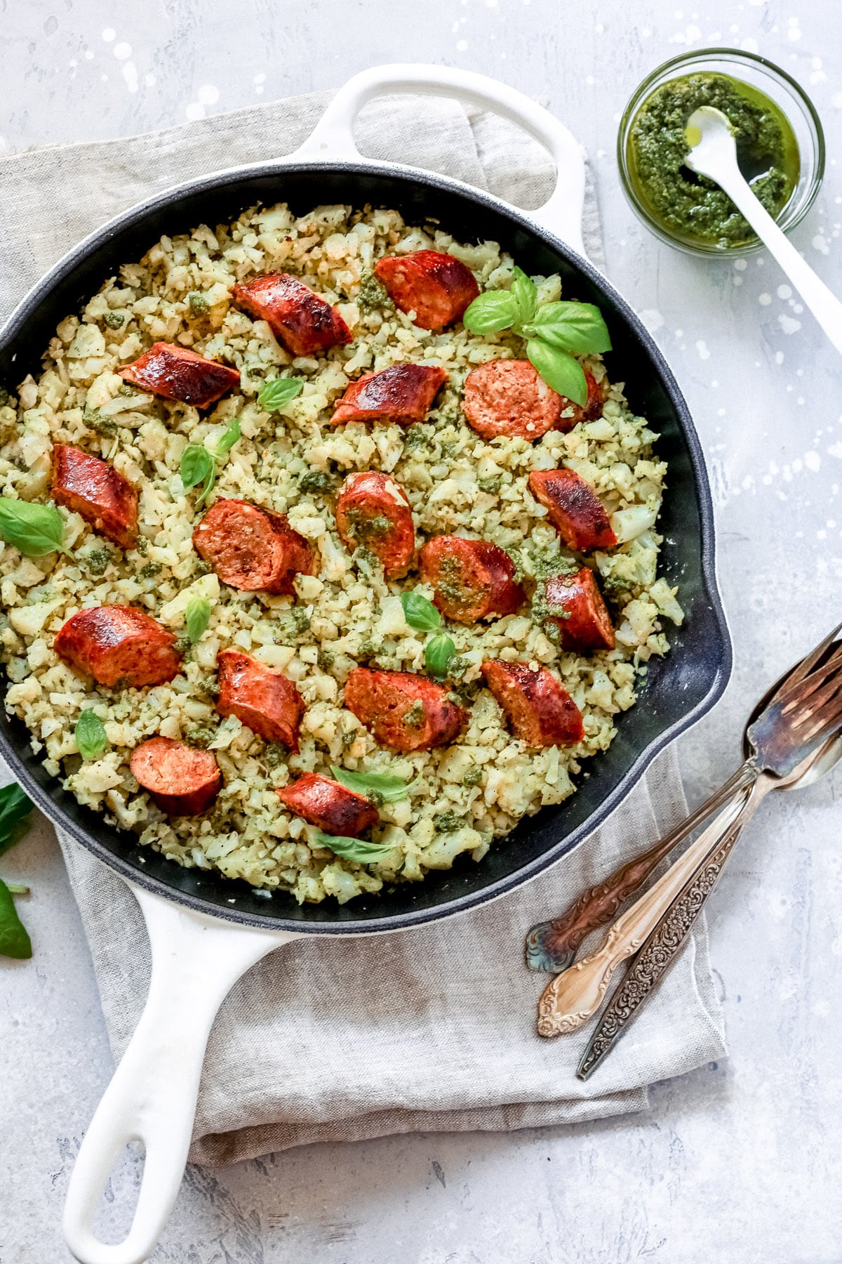 overhead view of a white skillet containing Italian Sausage and Cauliflower Rice 