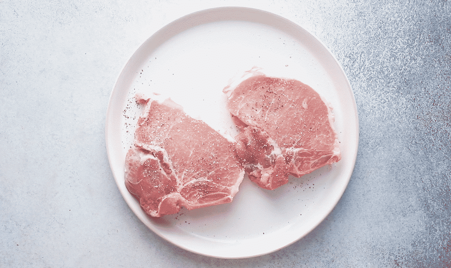 season pork chops with salt and black pepper