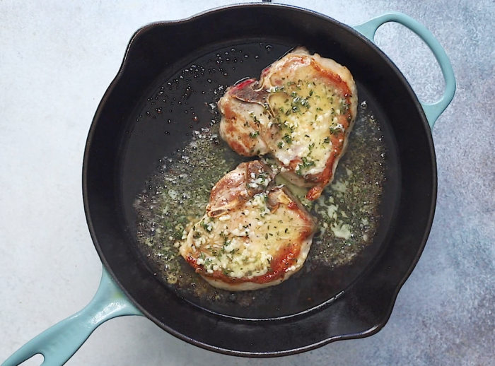 pour garlic butter on top of the pork chops