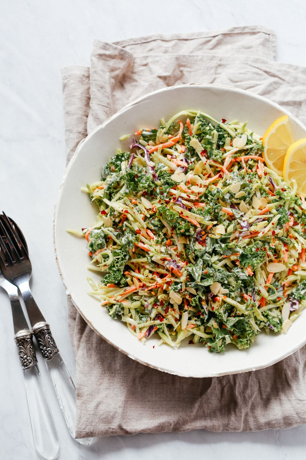 Overhead photo of a white plate of broccoli kale slaw salad. 