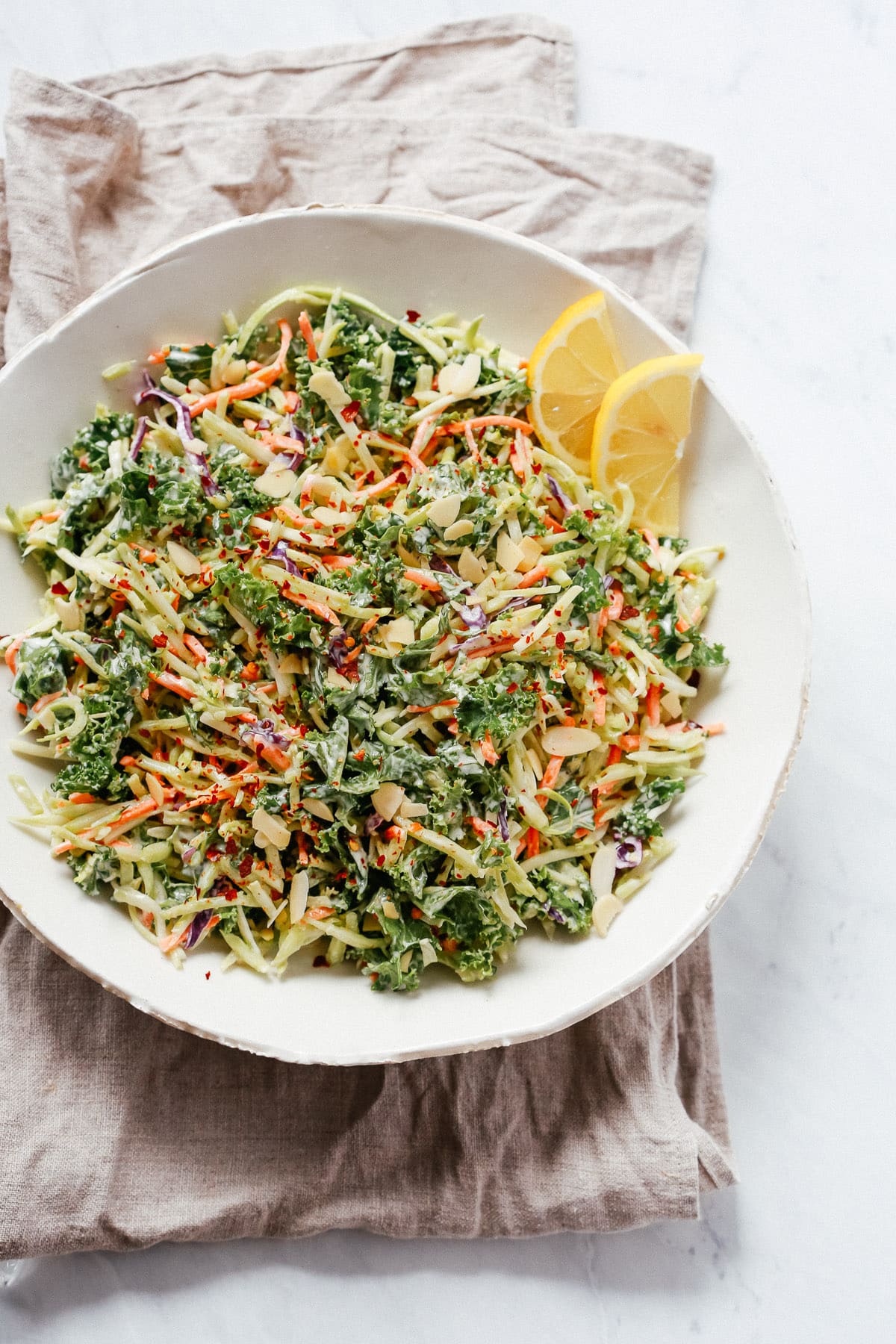 overhead view of broccoli slaw salad on a white bowl