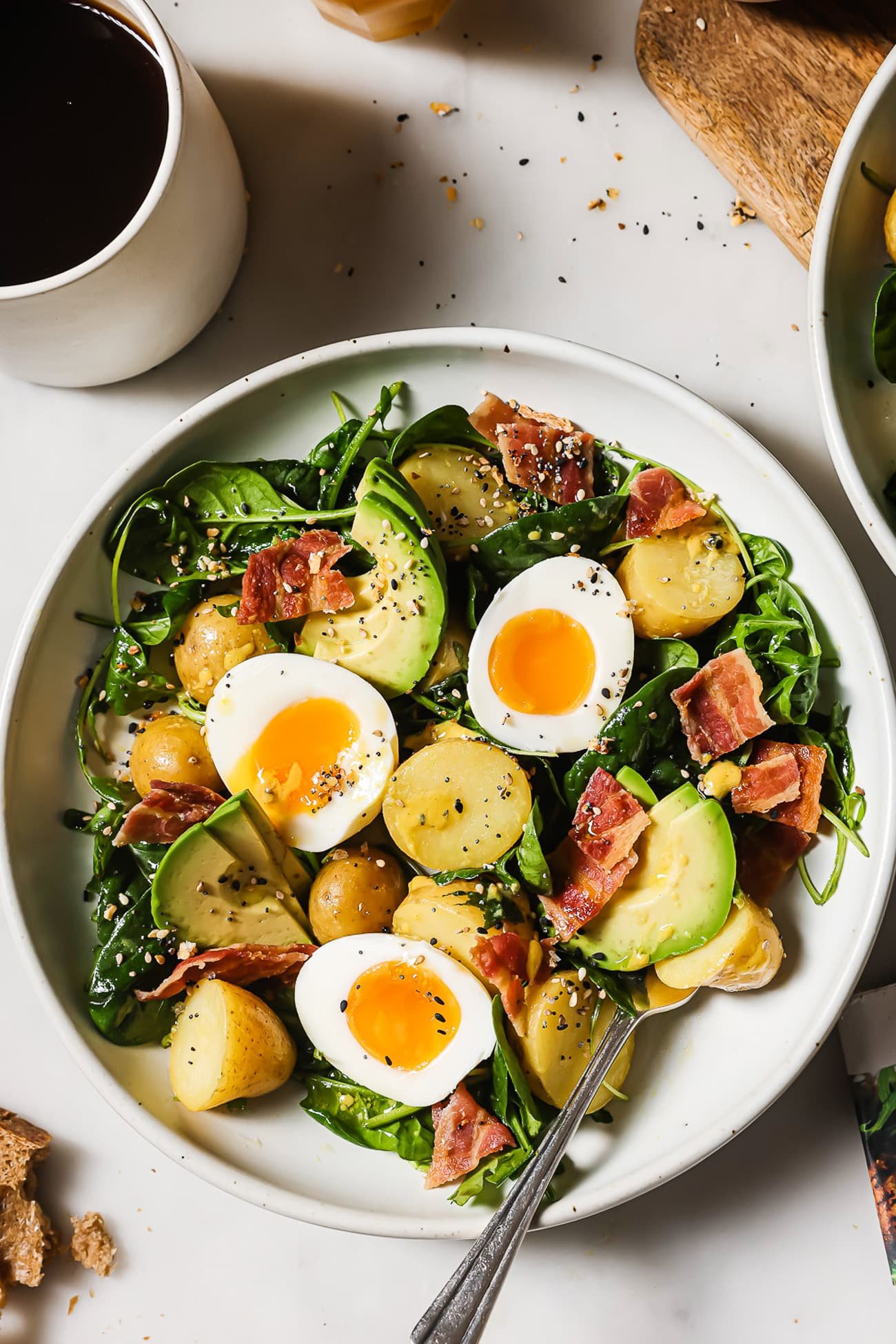 An overhead view of breakfast salad in a white serving bowl.