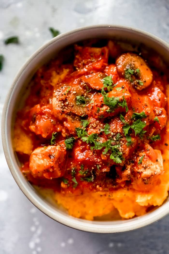 overhead view of chicken stroganoff with butternut squash mash inside of a grey bowl