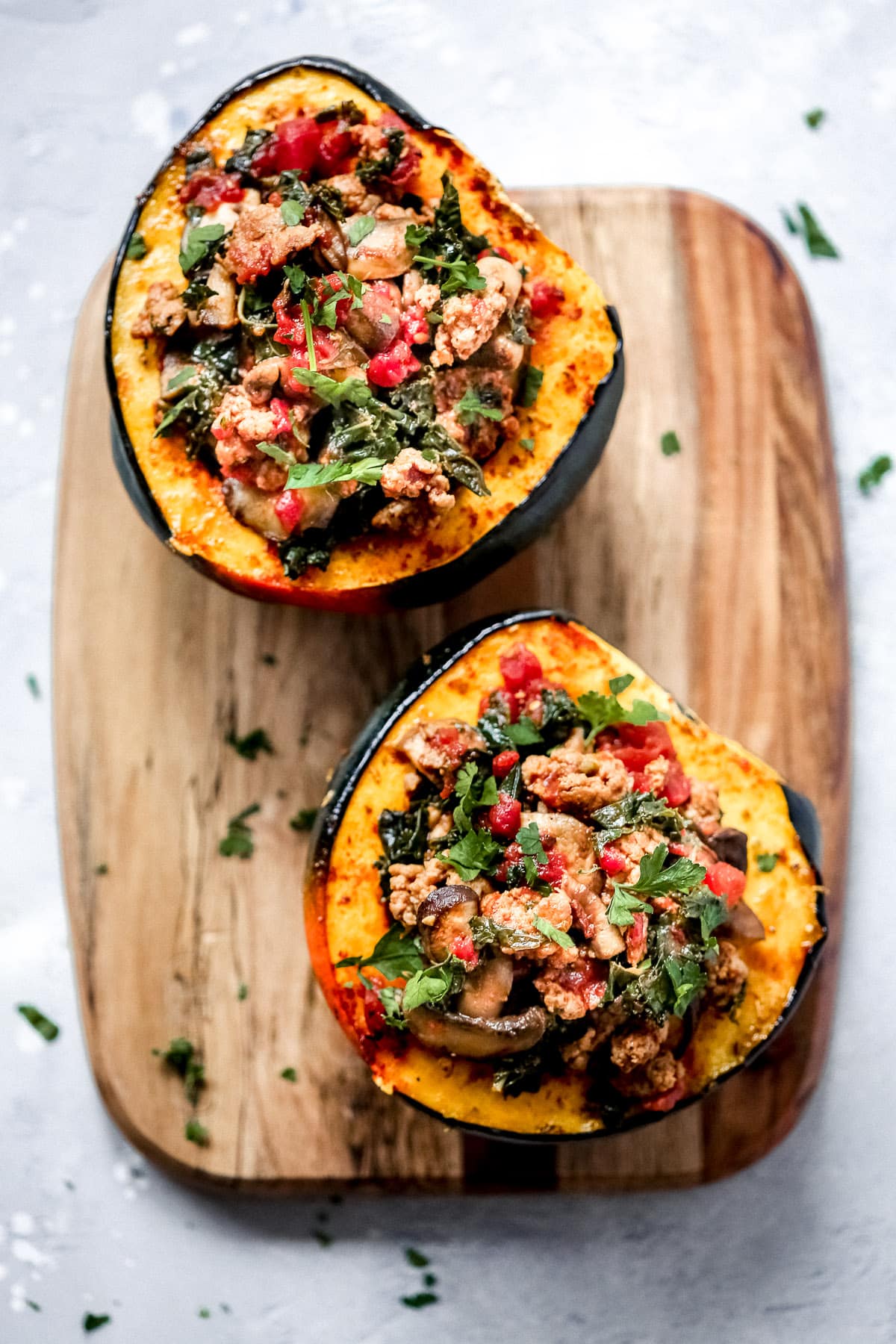 overhead view of sausage and kale stuffed acorn squash 