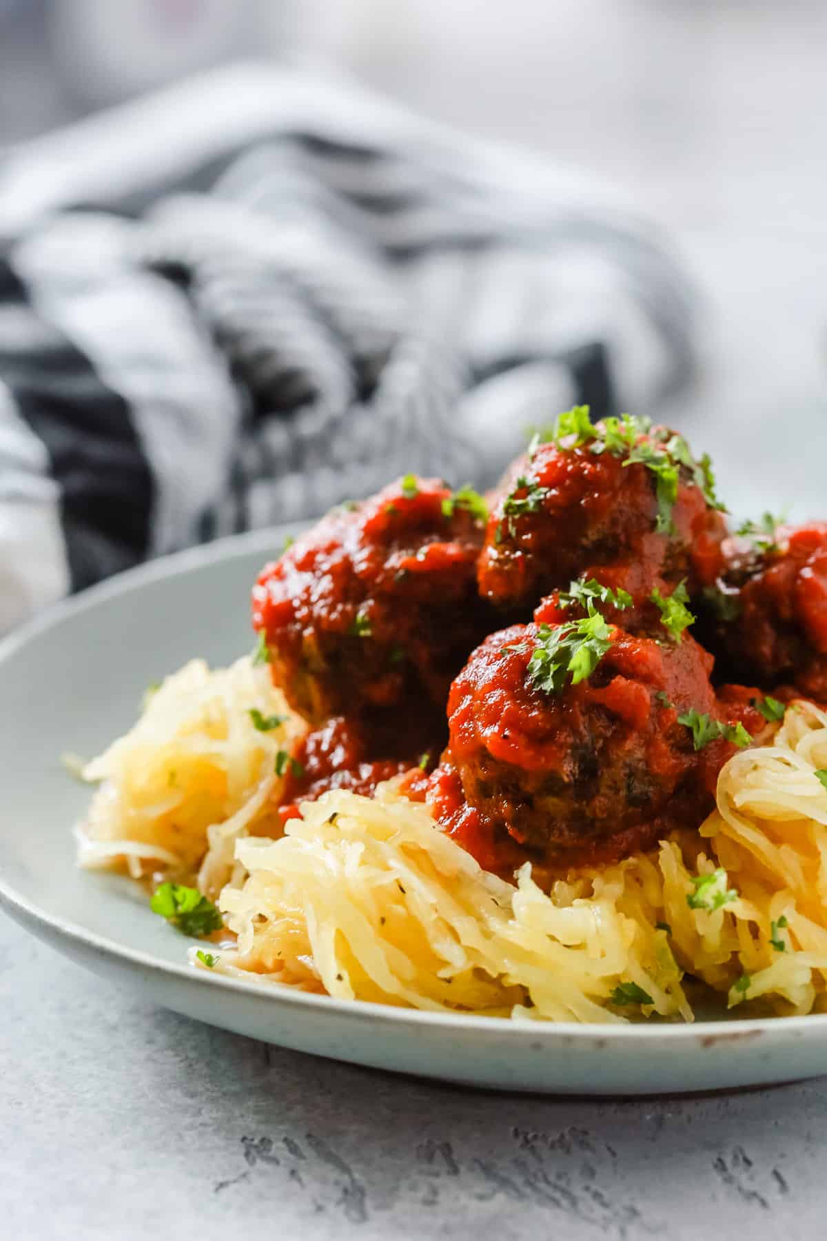 A close up of a plate containing Spaghetti Squash and Meatballs
