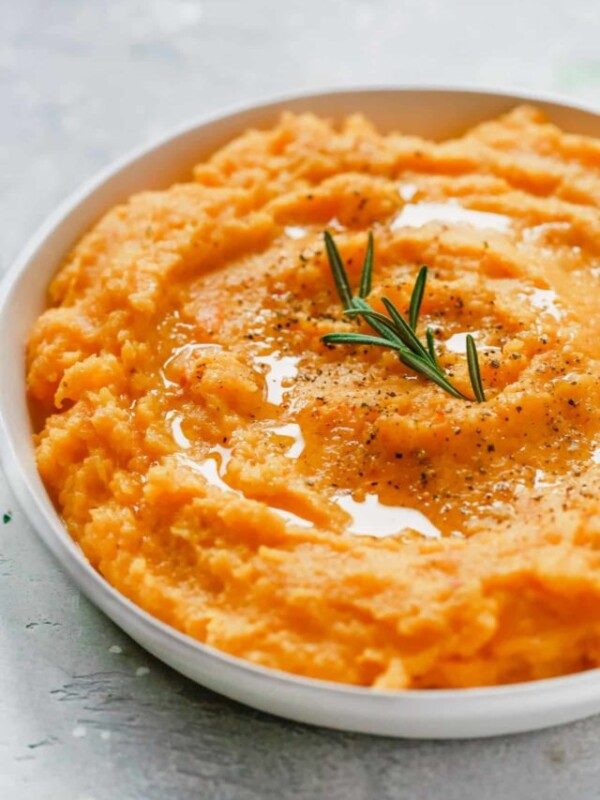 closeup of a roasted butternut squash mash in a white bowl