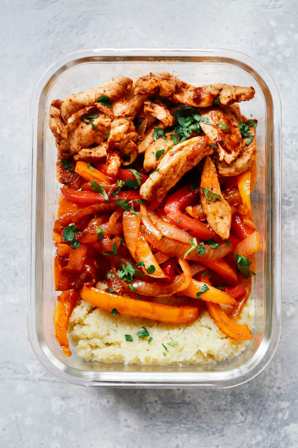 Close up of a fajita chicken meal prep bowl. 