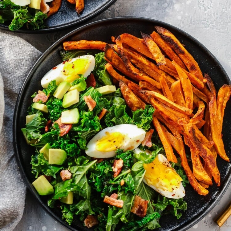 overhead view of a kale salad with sweet potato plate