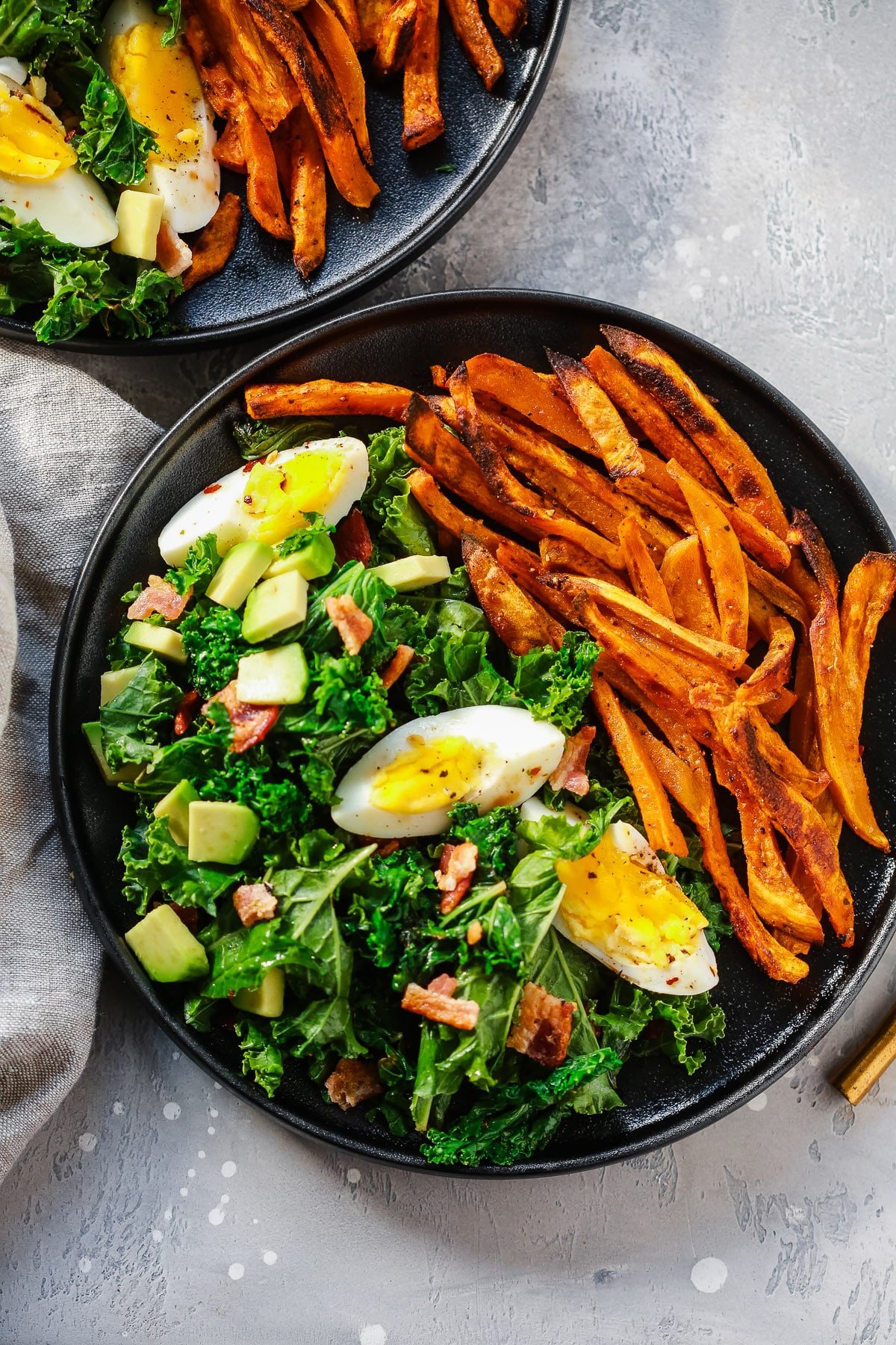 overhead view of a kale salad with sweet potato plate 