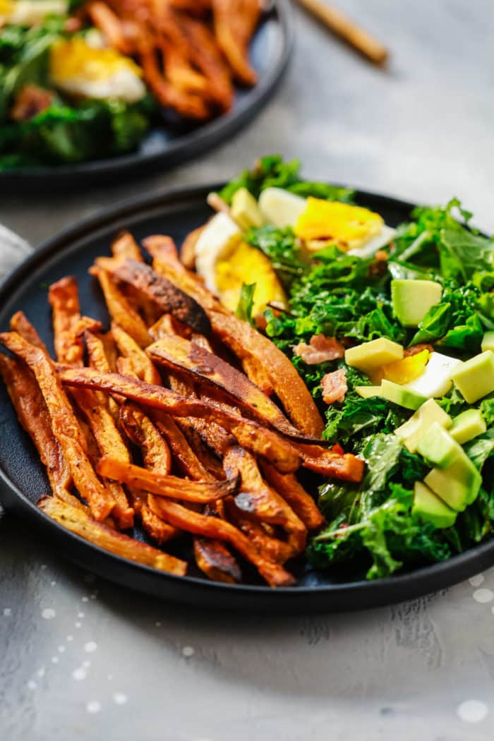 close-up kale salad on a black plate