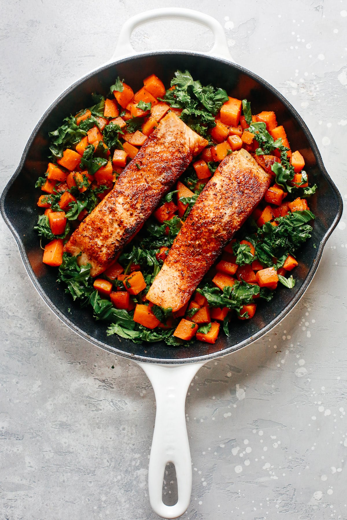 overhead view of a white skillet containing Salmon Sweet Potato inside.