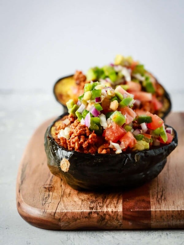 close up view of taco stuffed scorn squash on a wooden serving