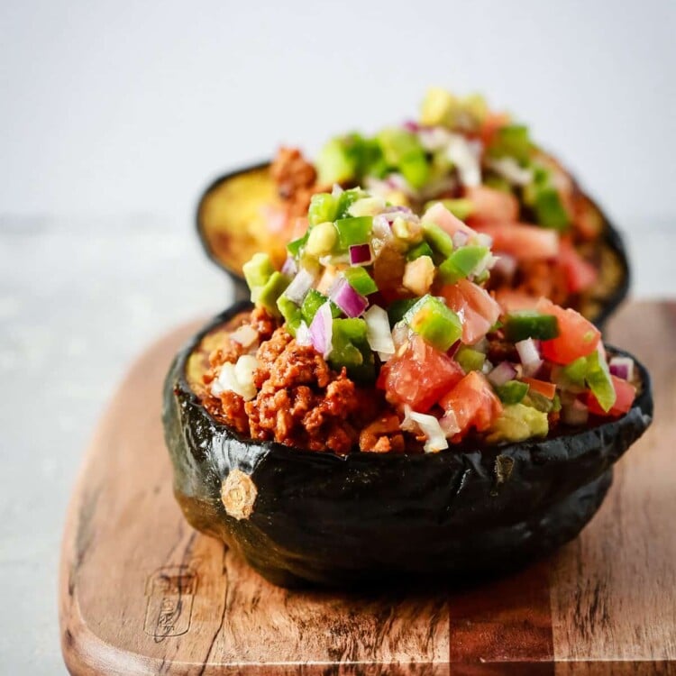 close up view of taco stuffed scorn squash on a wooden serving