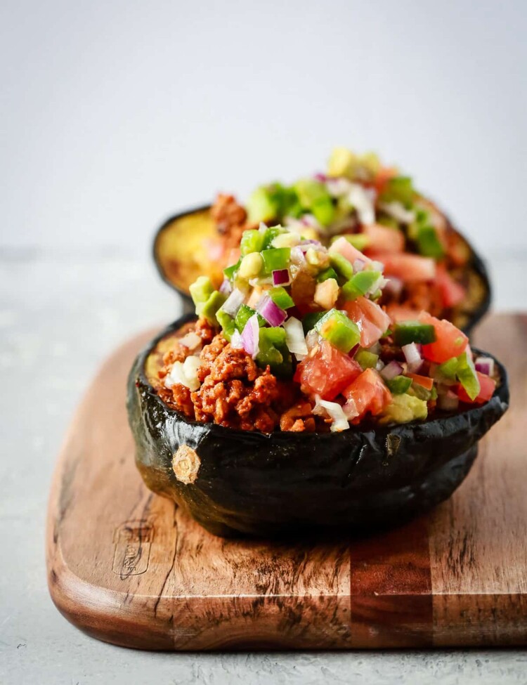 close up view of taco stuffed scorn squash on a wooden serving