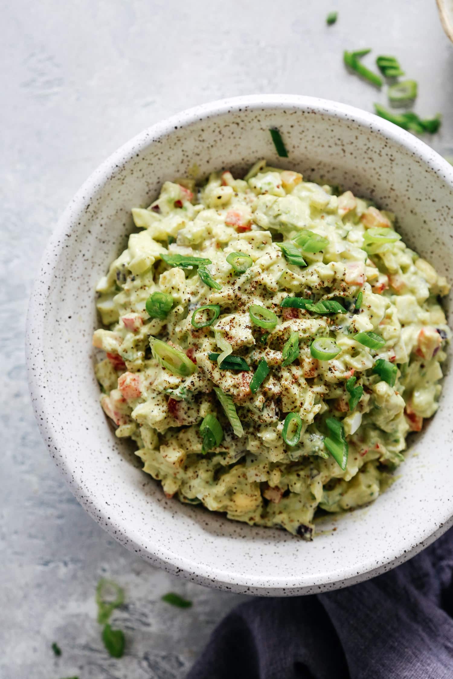overhead view of avocado egg salad in a grey bowl