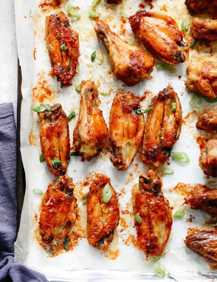 caked chicken wings in a sheet pan