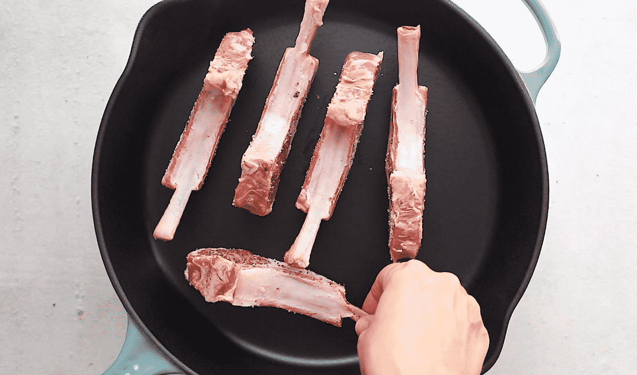Lamb chops seared on the sides in a pan to render the fat.