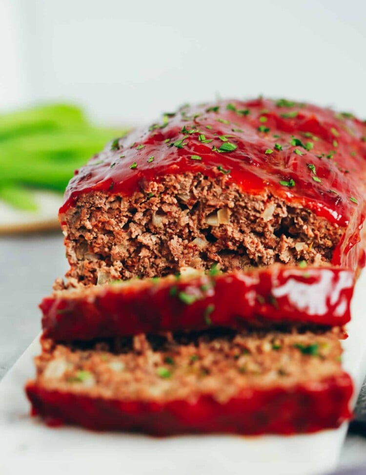 healthy turkey meatloaf with two slices cut from the loaf