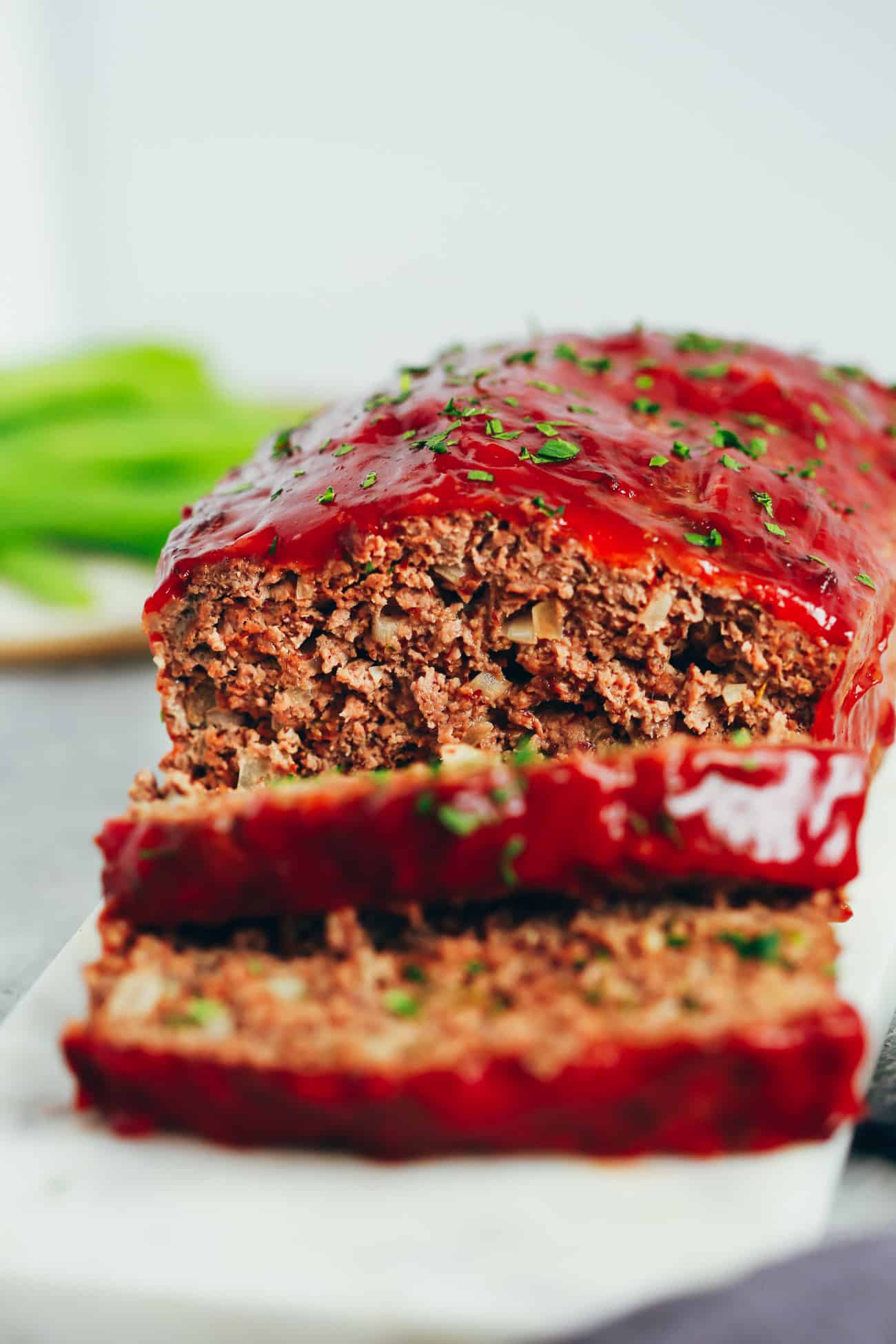healthy turkey meatloaf with two slices cut from the loaf 
