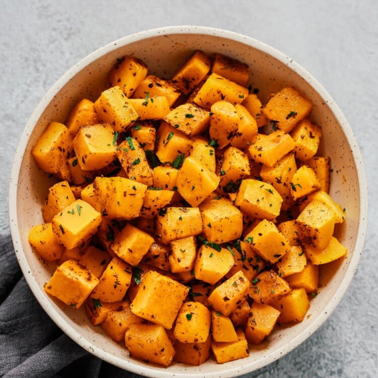 Overhead photo of a white bowl of roasted butternut squash.