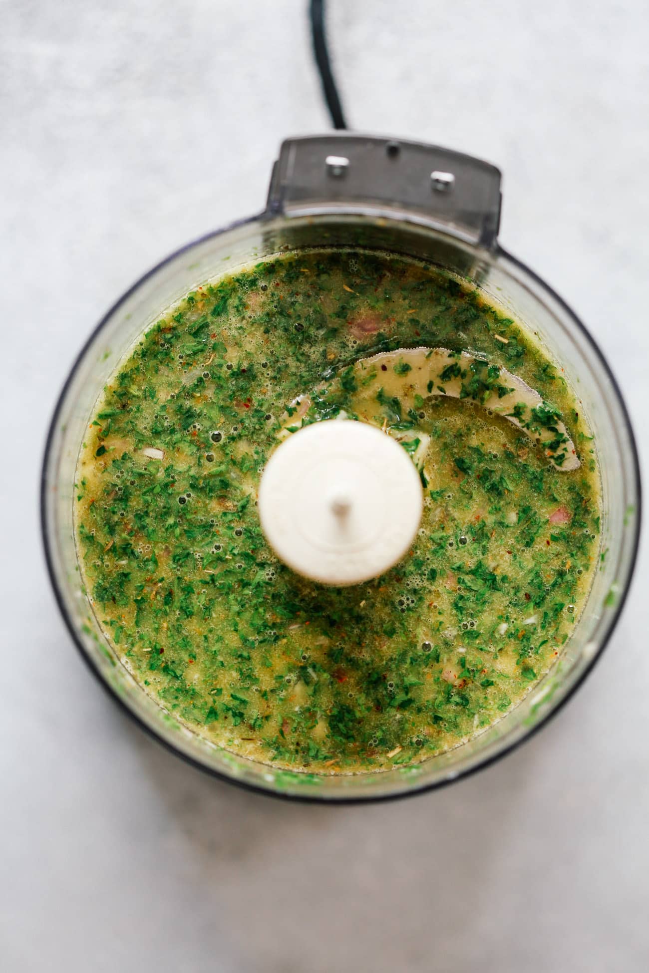 Making a chimichurri sauce recipe in a food processor 