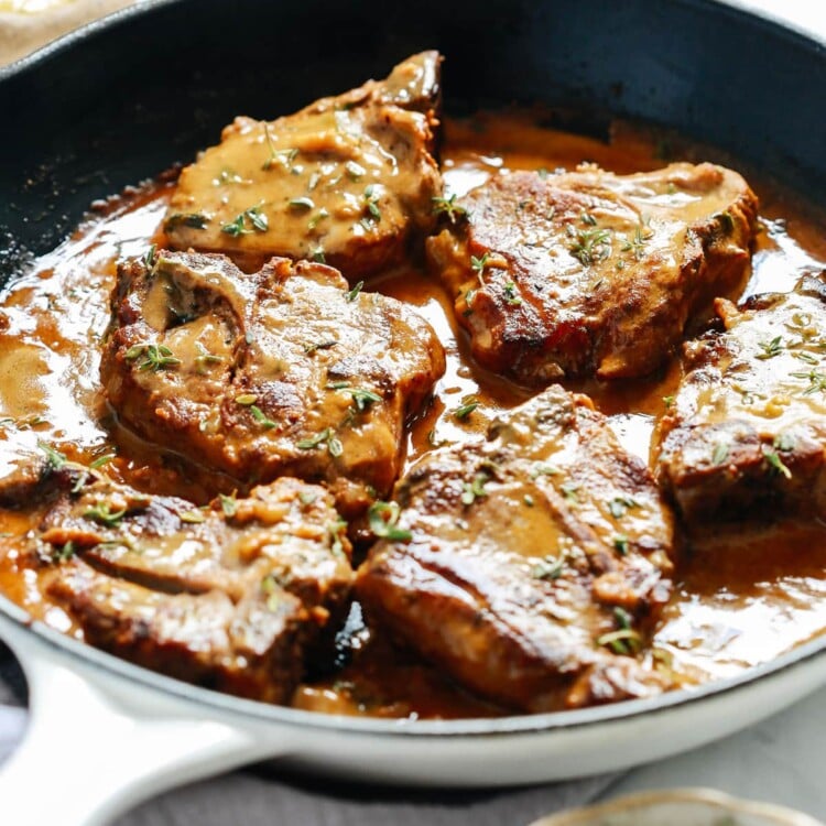 lamb chops with creamy mustard sauce in skillet