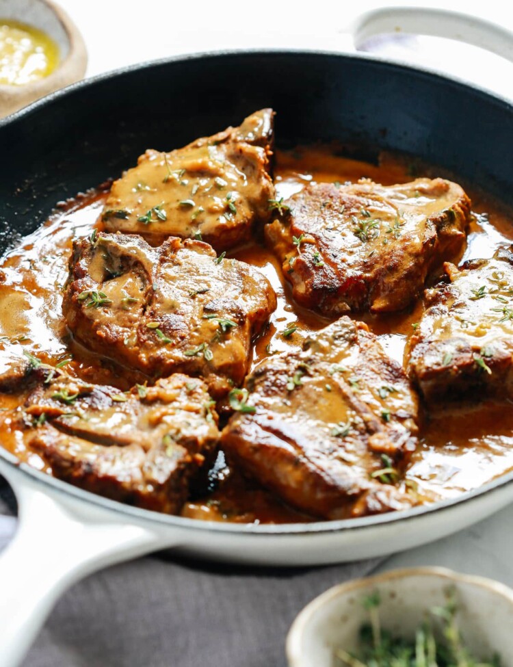 lamb chops with creamy mustard sauce in skillet