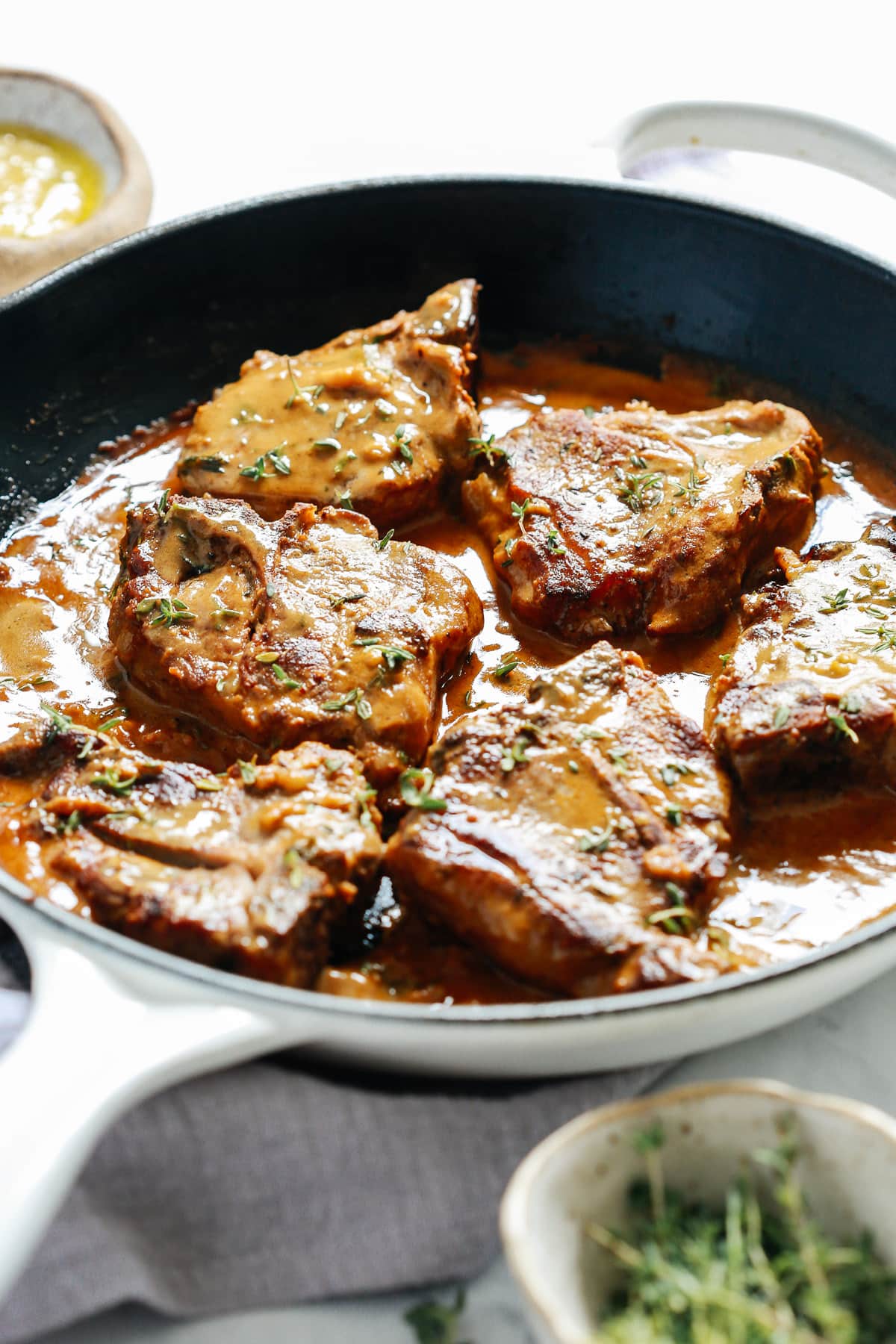 lamb chops with creamy mustard sauce in skillet