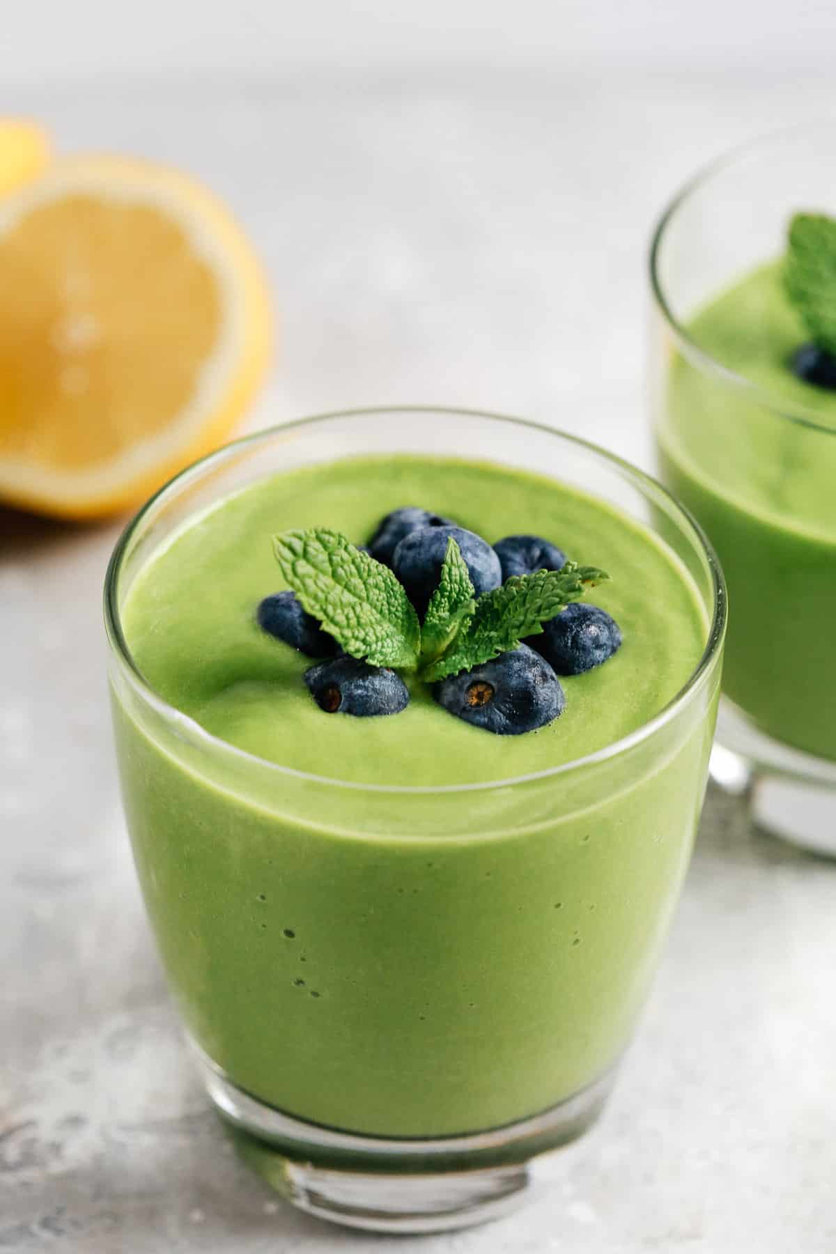 This low carb green smoothie tastes great and provides healthy fats, protein and necessary fiber, all in one glass. Make this recipe in under 5 minutes! close up of a glass full with green smoothie