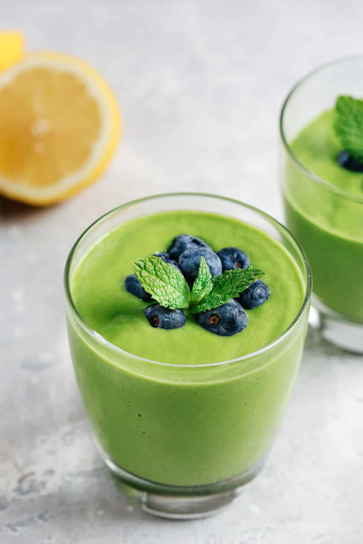 close up view of a glass containing green smoothie 