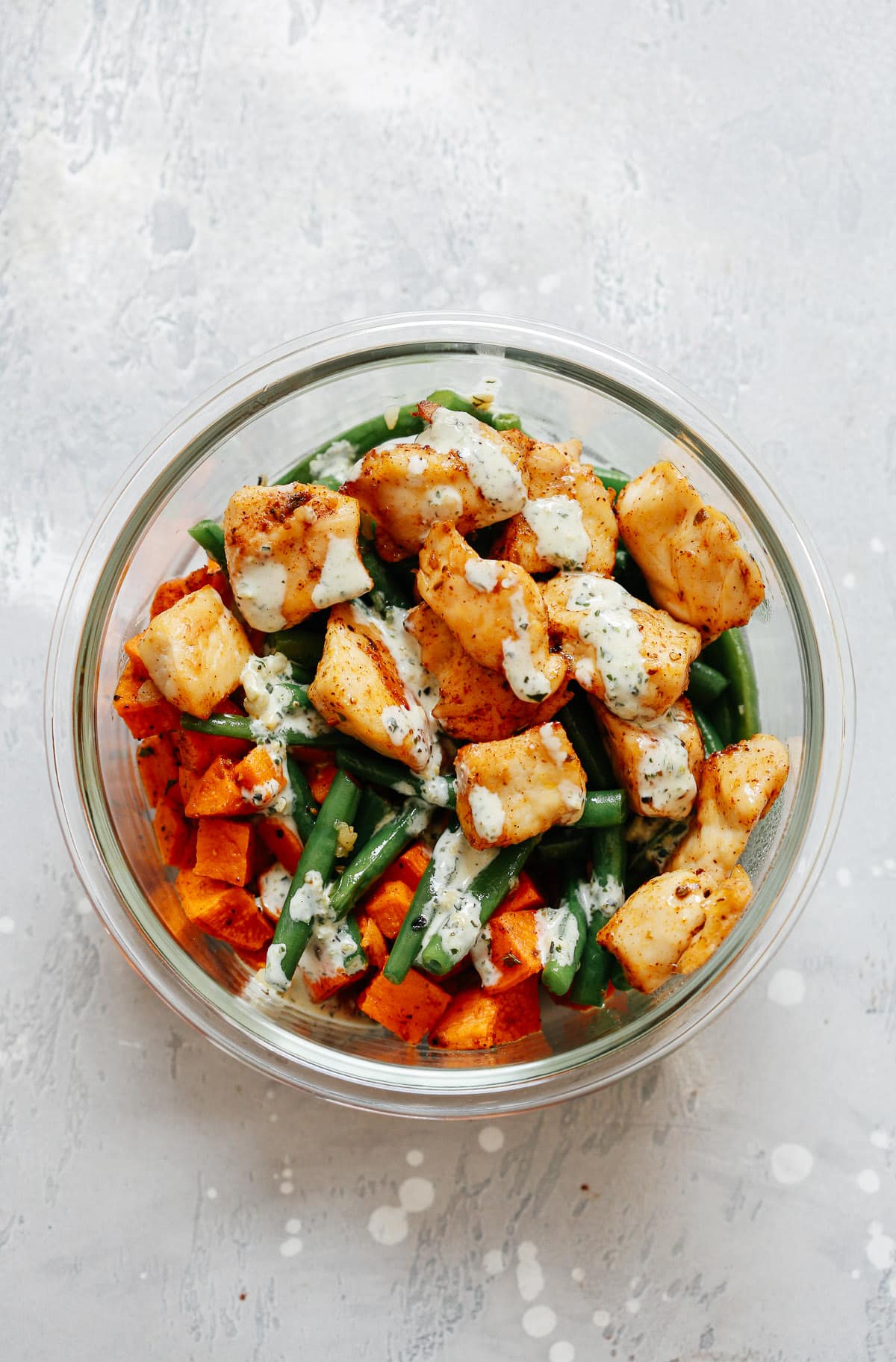 meal prep dinner of chicken and vegetables in pesto sauce