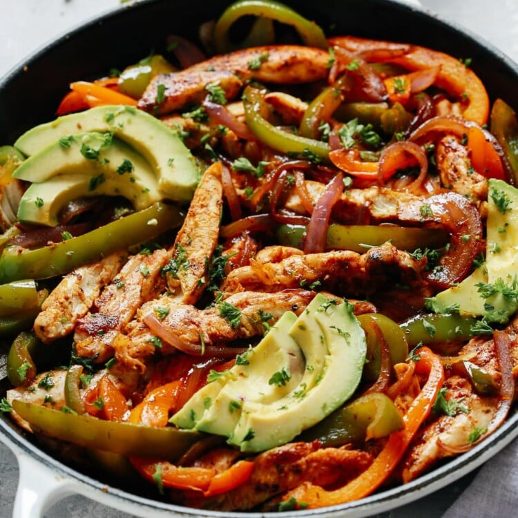 chicken fajitas topped with avocado slices