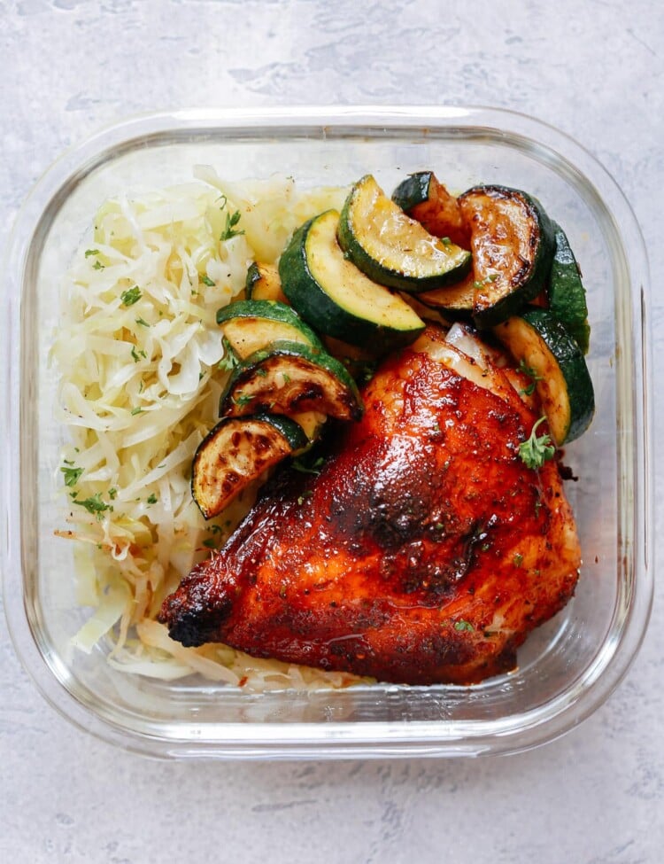 Spicy Chicken with Sauteed Cabbage and Zucchini in glass meal prep container