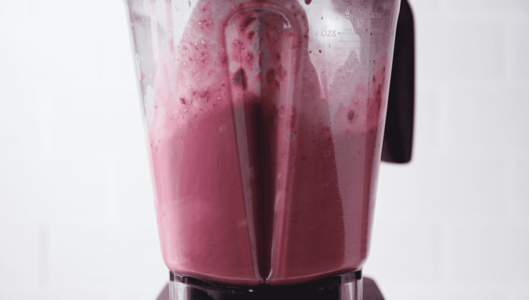 close up of a blender jr containing raspberry smoothie