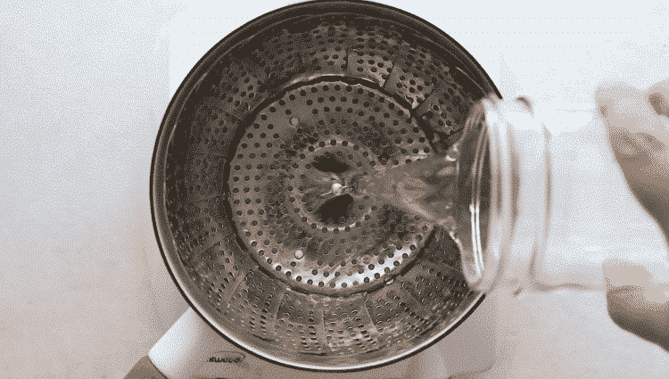 overhead view of someone filling a pan with water