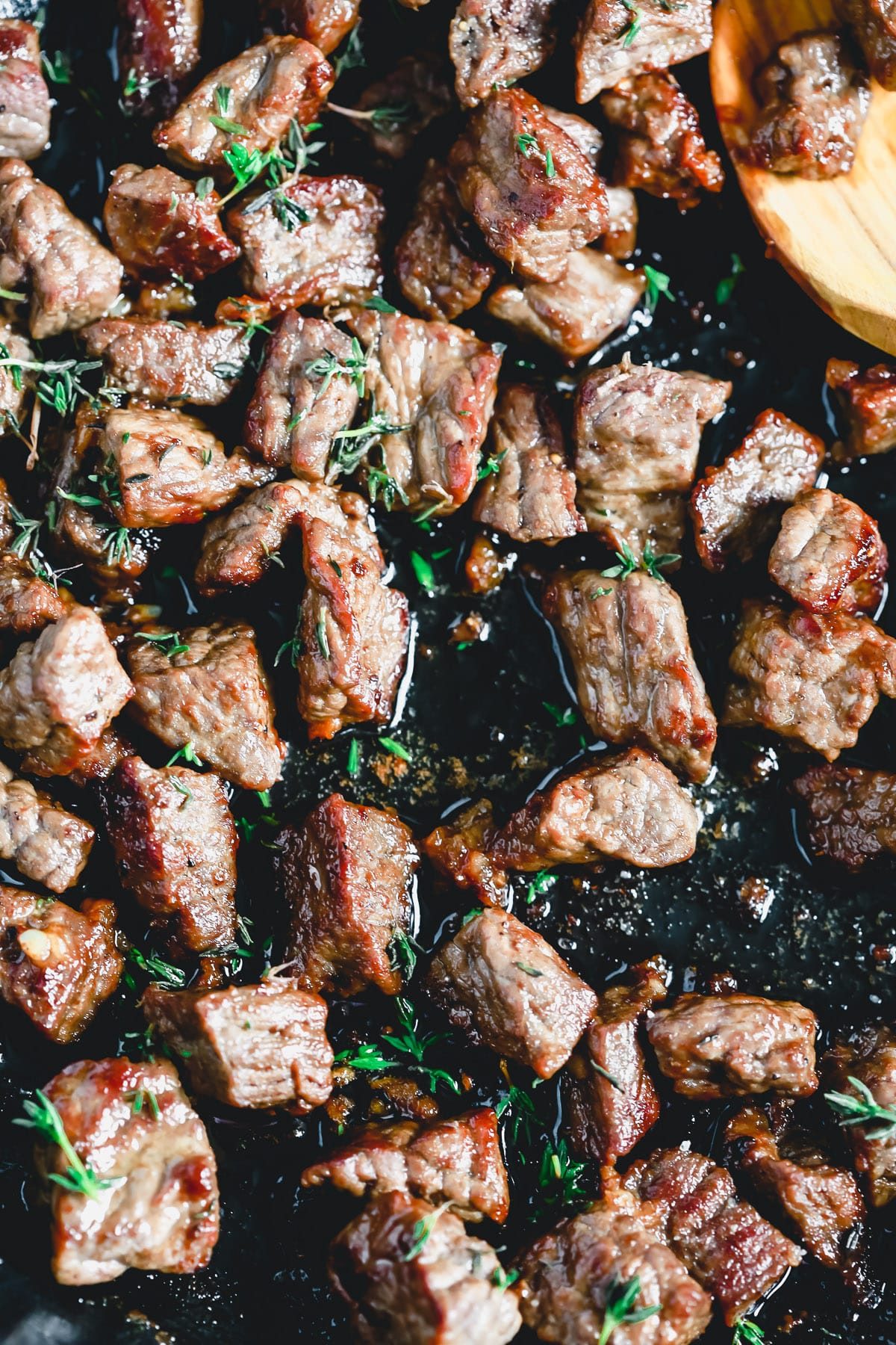 closeup image of sirloin steak bites in pan